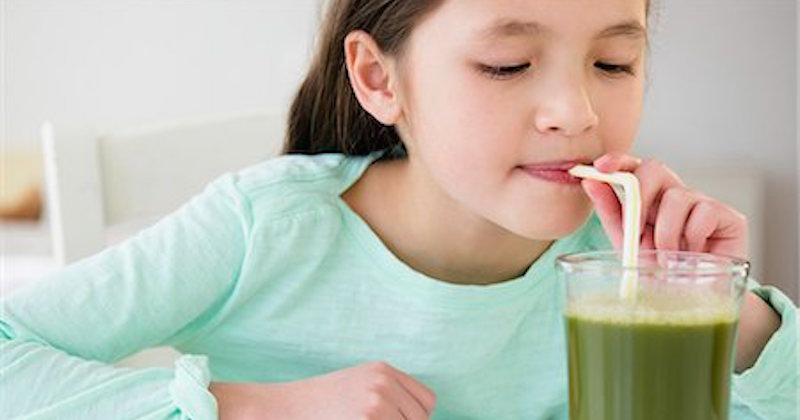 girl drinking green juice
