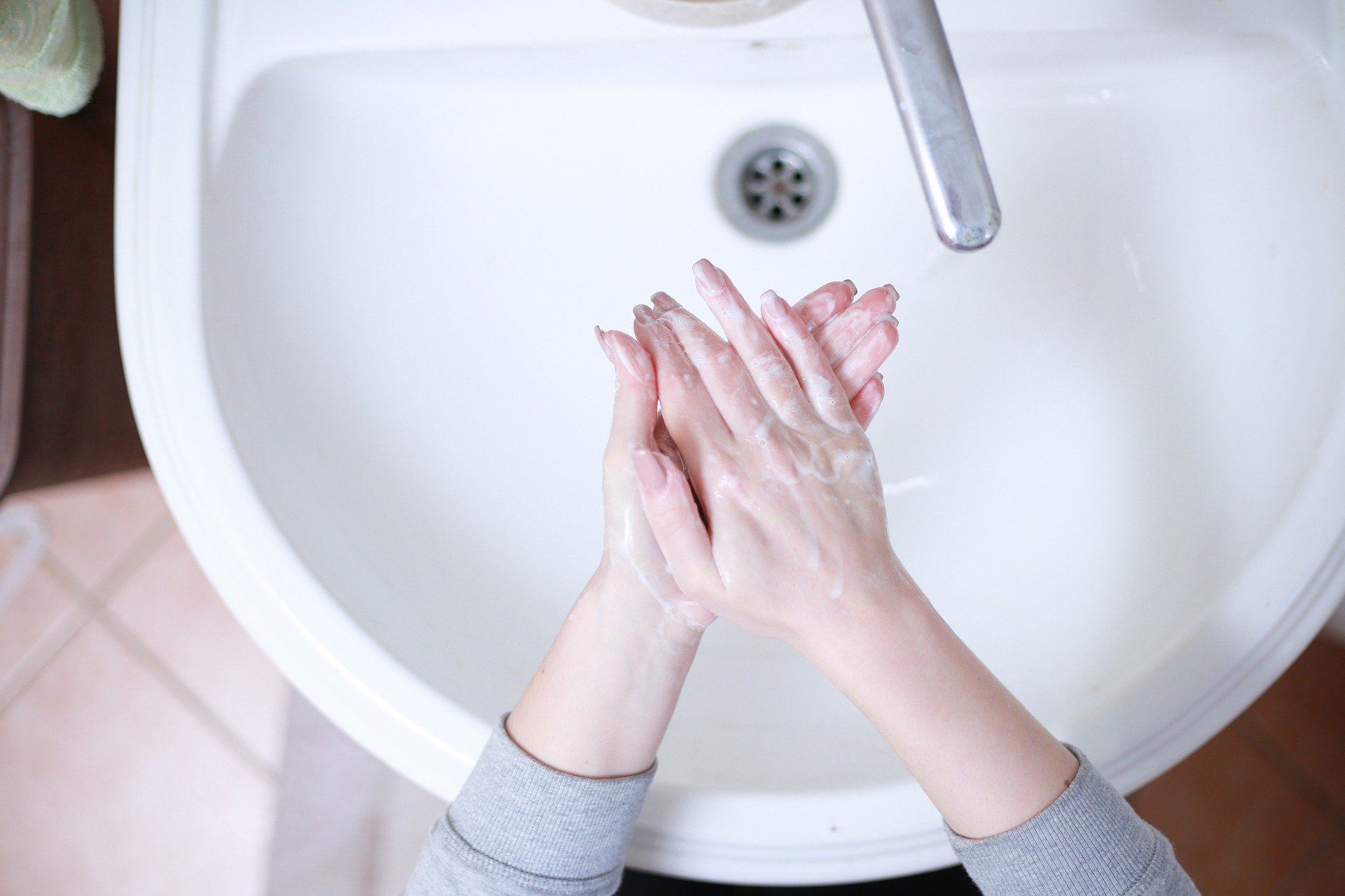 Woman washing her hands to stop the spread of viruses.